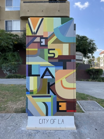 A decorated utility box with geometric shapes. 